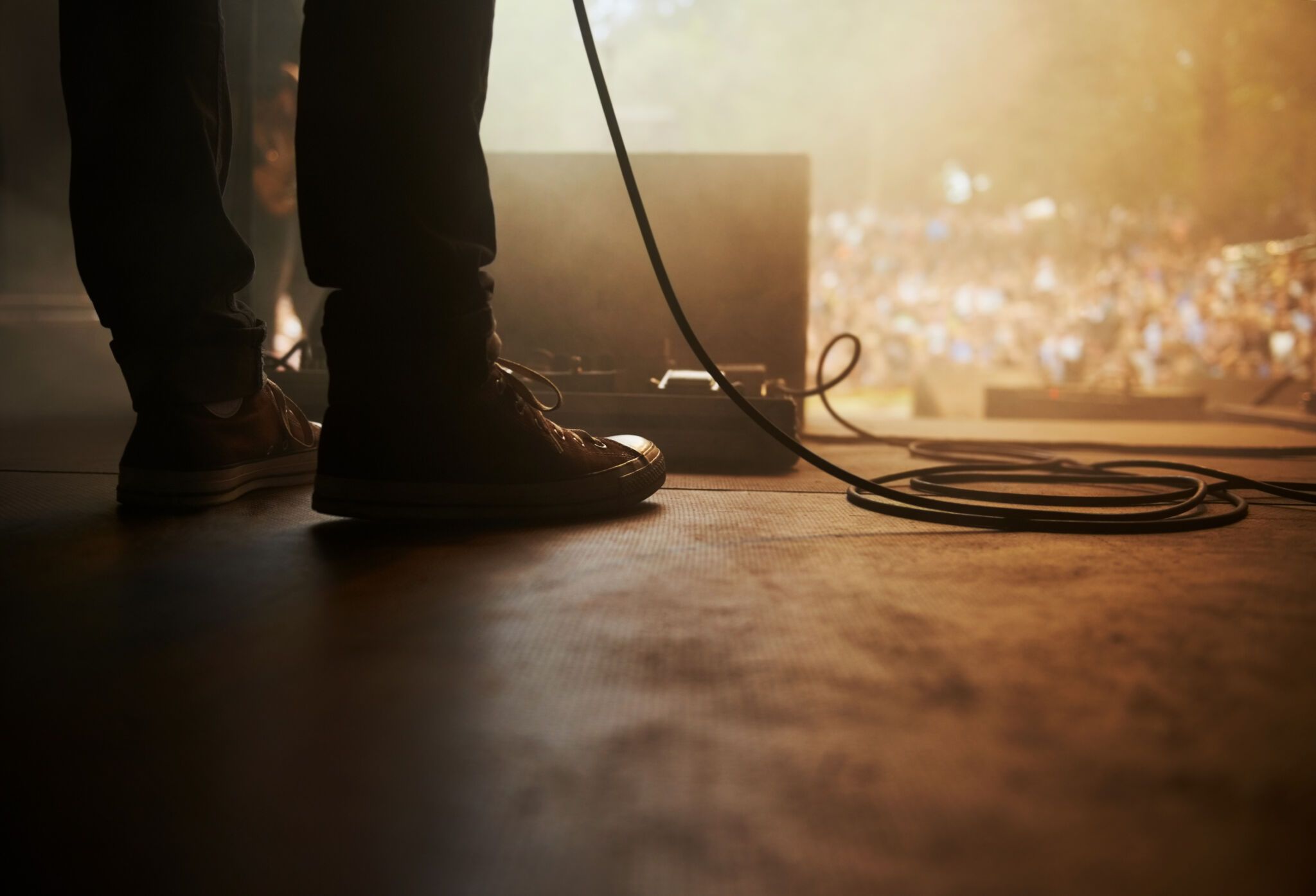 Cropped shot of a musician's feet on stage at an outdoor music festival